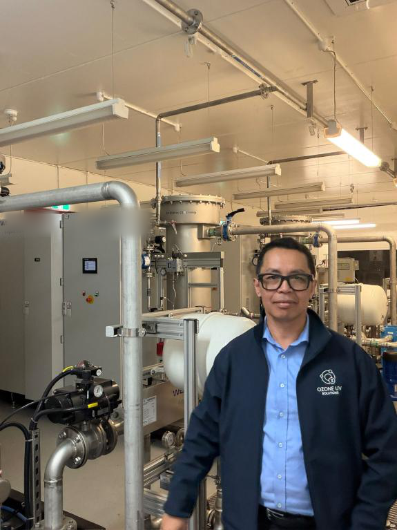 Jonathan Andry, Founder and Principal Engineer, in a plant room beside ozone treatment equipment
