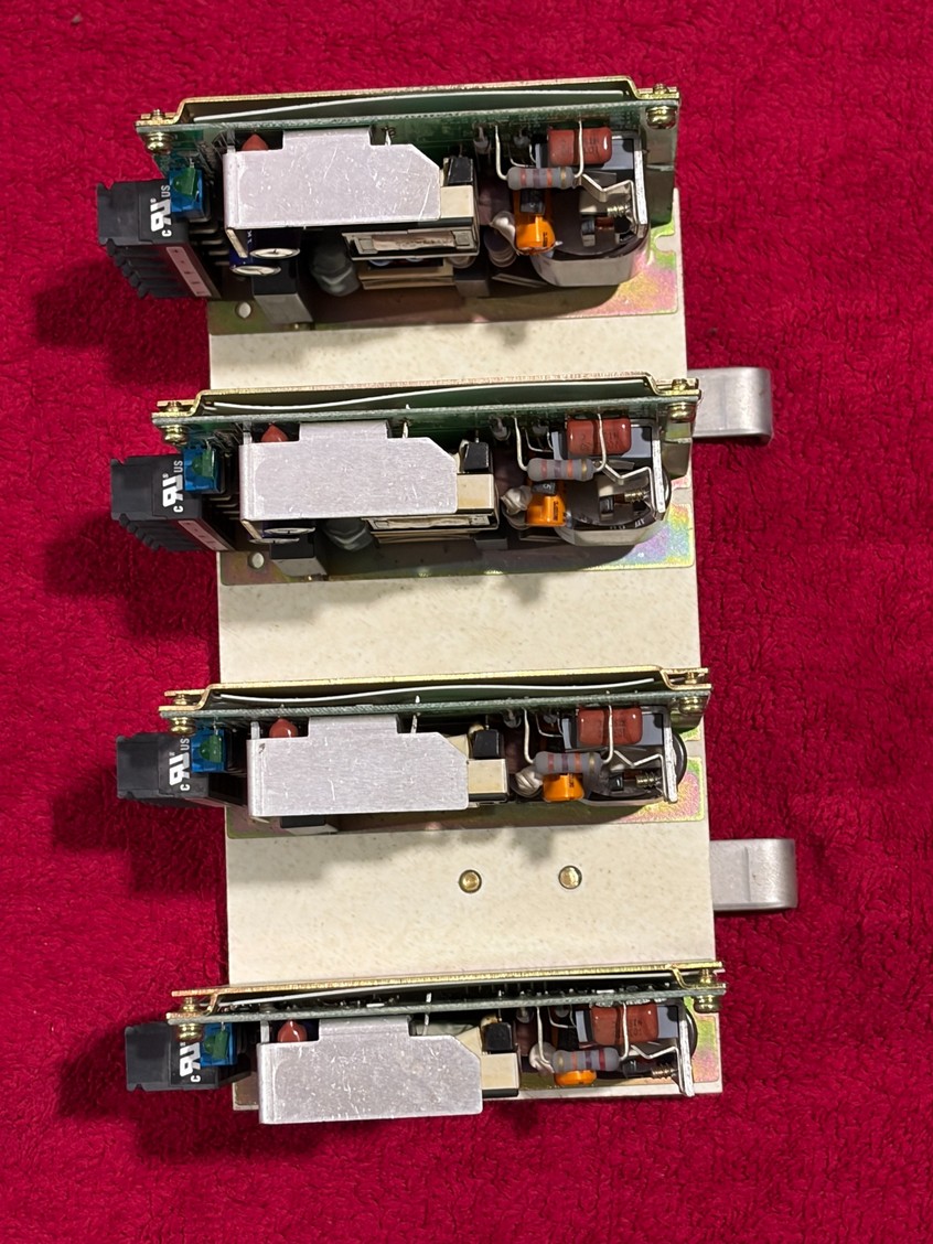 Four matching power electronics modules mounted on a common frame.